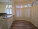 Sunlit dining area featuring wood floors, modern lighting, and shuttered windows at 9329 Fresh Spring Dr, Las Vegas, NV 89134