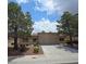 Inviting single-story home with a well-manicured front yard and mature trees at 9329 Fresh Spring Dr, Las Vegas, NV 89134
