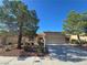 Charming single-story home with a well-manicured front yard and inviting curb appeal, set beneath a clear blue sky at 9329 Fresh Spring Dr, Las Vegas, NV 89134