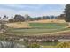 Beautiful view of the well-maintained golf course with vibrant green grass and a tranquil pond at 9329 Fresh Spring Dr, Las Vegas, NV 89134