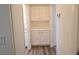 Hallway featuring built-in cabinets for storage, with wood flooring, and a doorway leading to the bathroom at 9329 Fresh Spring Dr, Las Vegas, NV 89134