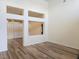 Bright living room with hardwood floors, large windows, and stylish architectural details at 9329 Fresh Spring Dr, Las Vegas, NV 89134