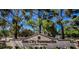 Entrance to Sun City Summerlin, a Del Webb community, with lush trees against a bright blue sky at 9329 Fresh Spring Dr, Las Vegas, NV 89134
