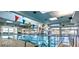 Indoor swimming pool with abundant natural light and clear blue water, perfect for year-round enjoyment at 9329 Fresh Spring Dr, Las Vegas, NV 89134