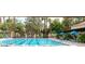 Outdoor swimming pool with lap lanes and poolside seating, surrounded by lush landscaping and palm trees at 9329 Fresh Spring Dr, Las Vegas, NV 89134