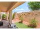 A cozy courtyard featuring a stone wall with decorative lizards at 9704 Morgan Creek Ct, Las Vegas, NV 89141