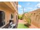 Private outdoor patio with stone pavers and decorative wall art at 9704 Morgan Creek Ct, Las Vegas, NV 89141