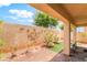 Private courtyard with artificial turf and stucco walls adorned with art at 9704 Morgan Creek Ct, Las Vegas, NV 89141