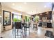 A cozy dining area filled with natural light, featuring dark wood cabinets in the nearby kitchen at 9704 Morgan Creek Ct, Las Vegas, NV 89141