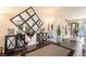 The entryway is equipped with a decorative mirror, hardwood floors, and elegant decor at 9704 Morgan Creek Ct, Las Vegas, NV 89141