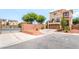 Two-story tan stucco home with an attached garage at 9704 Morgan Creek Ct, Las Vegas, NV 89141