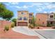 Two-story tan stucco home with a balcony, attached garage, and desert landscaping at 9704 Morgan Creek Ct, Las Vegas, NV 89141