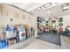 Functional garage featuring a home gym and ample storage with overhead lighting at 9704 Morgan Creek Ct, Las Vegas, NV 89141