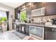 Updated kitchen boasts dark cabinets, granite countertops, and stainless steel appliances at 9704 Morgan Creek Ct, Las Vegas, NV 89141