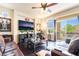 Living room with dark wood floors and a balcony view at 9704 Morgan Creek Ct, Las Vegas, NV 89141