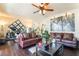 Inviting living room features hardwood floors, ceiling fan, and a decorative diamond mirror at 9704 Morgan Creek Ct, Las Vegas, NV 89141