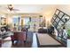 Bright living room features hardwood floors, large windows, and a modern decorative mirror at 9704 Morgan Creek Ct, Las Vegas, NV 89141