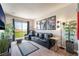 Living room features comfortable seating, stylish decor and a sliding door to the balcony at 9704 Morgan Creek Ct, Las Vegas, NV 89141