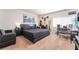 Spacious bedroom featuring a queen bed, seating area, desk and a large window at 9704 Morgan Creek Ct, Las Vegas, NV 89141
