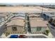 An aerial view showing several homes featuring desert landscaping and multiple car driveways at 9929 Bumblebee Hills St, Las Vegas, NV 89141