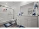 Well-lit bathroom features a glass-enclosed shower, wood look flooring, and vanity sink at 9929 Bumblebee Hills St, Las Vegas, NV 89141