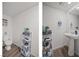 Cozy half-bathroom featuring a pedestal sink and shelving unit at 9929 Bumblebee Hills St, Las Vegas, NV 89141