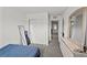 Bright bedroom features neutral walls and floors, a full length mirror, and closet with sliding doors at 9929 Bumblebee Hills St, Las Vegas, NV 89141