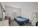 Bright bedroom with large window features an office desk, chair, and modern decor at 9929 Bumblebee Hills St, Las Vegas, NV 89141