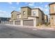 Exterior view of modern townhomes with attached garages, showcasing neutral tones and clean architectural lines at 9929 Bumblebee Hills St, Las Vegas, NV 89141