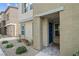 Modern home with a textured facade, complemented by desert landscaping and a covered entryway at 9929 Bumblebee Hills St, Las Vegas, NV 89141