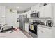 Bright kitchen featuring stainless steel appliances and white cabinetry at 9929 Bumblebee Hills St, Las Vegas, NV 89141