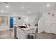 Open-concept kitchen with island, stainless steel sink, and wood flooring at 9929 Bumblebee Hills St, Las Vegas, NV 89141