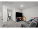 Spacious living room with plush seating, TV, and a view to the hallway at 9929 Bumblebee Hills St, Las Vegas, NV 89141