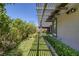 Landscaped backyard with manicured green lawn, shrubbery, and a covered patio off the home at , Las Vegas, NV 89148