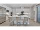 Bright kitchen with white cabinets, a large island, stainless steel appliances, and barstool seating at , Las Vegas, NV 89148