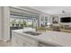 Modern kitchen island with a sink, stainless steel appliances, and view to the covered outdoor patio at , Las Vegas, NV 89148