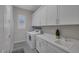 Well-lit laundry room featuring ample cabinet space and modern washing machine and dryer at , Las Vegas, NV 89148