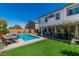 Serene backyard featuring a swimming pool with spa, pergola, outdoor dining, and low-maintenance turf at 10420 Loma Portal Ave, Las Vegas, NV 89166