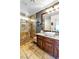 Beautiful bathroom featuring a granite countertop, wood cabinets, and a luxurious tiled shower, adding elegance to the space at 10420 Loma Portal Ave, Las Vegas, NV 89166