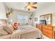 Cozy bedroom featuring ample natural light, neutral colors, ceiling fan, and a comfortable king-size bed at 10420 Loma Portal Ave, Las Vegas, NV 89166