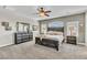 Spacious bedroom with a ceiling fan, plush carpeting, and natural light creates a serene and comfortable atmosphere at 10420 Loma Portal Ave, Las Vegas, NV 89166