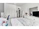 Bright bedroom features white walls, plush bedding, and a vanity area, creating a cozy and inviting space at 10420 Loma Portal Ave, Las Vegas, NV 89166