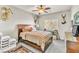 Cozy bedroom featuring ample natural light, neutral colors, ceiling fan, and a comfortable king-size bed at 10420 Loma Portal Ave, Las Vegas, NV 89166