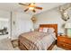 Bedroom featuring ample natural light, neutral colors, ceiling fan, and a comfortable king-size bed at 10420 Loma Portal Ave, Las Vegas, NV 89166