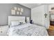 This bedroom boasts a gray accent wall, closet space, and plush white bedding creating a peaceful retreat at 10420 Loma Portal Ave, Las Vegas, NV 89166