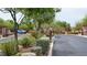 Gated community entrance with lush landscaping and secure access for residents and visitors at 10420 Loma Portal Ave, Las Vegas, NV 89166