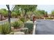 Gated community entrance with lush landscaping, ensuring privacy and security for residents at 10420 Loma Portal Ave, Las Vegas, NV 89166