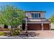 Lovely two-story home features a three-car garage, stone accents, and a well-maintained yard at 10420 Loma Portal Ave, Las Vegas, NV 89166
