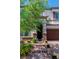 Charming two-story home with brick accents around the entrance, and a well-manicured yard at 10420 Loma Portal Ave, Las Vegas, NV 89166