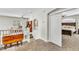 Hallway landing with furniture, and a view into another room with a bed and slider door, adding character to the house at 10420 Loma Portal Ave, Las Vegas, NV 89166